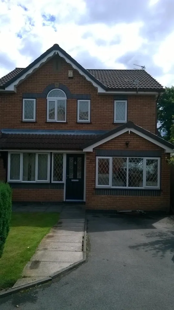White uPVC diamond leaded windows on red brick house