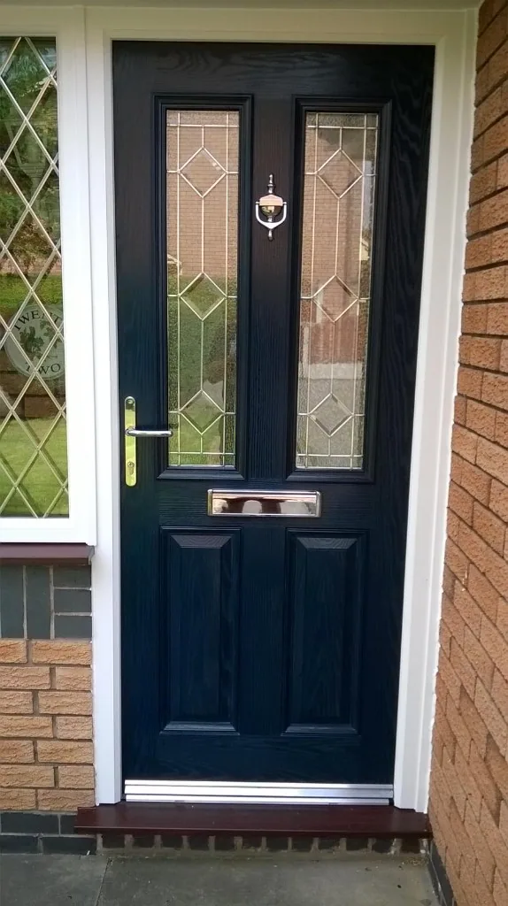 Navy blue composite front door with decorative leaded glass
