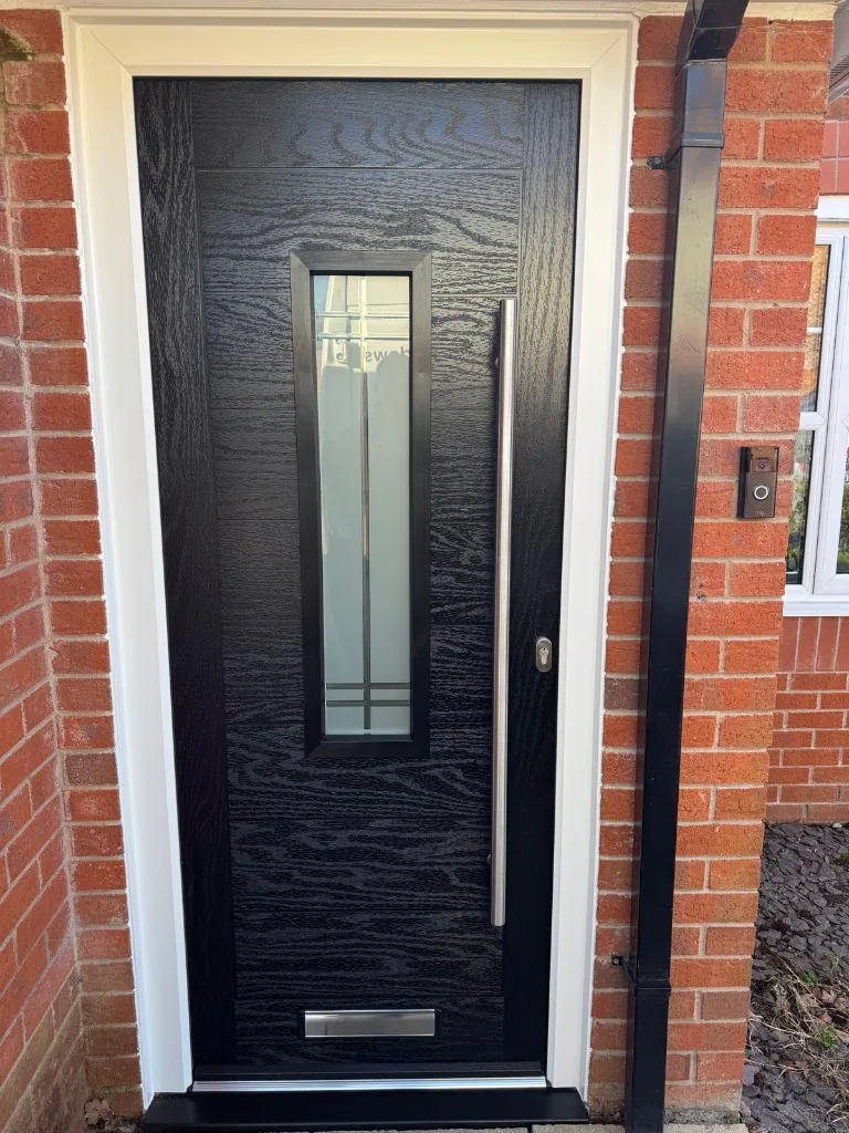 Black composite front door with long bar handle