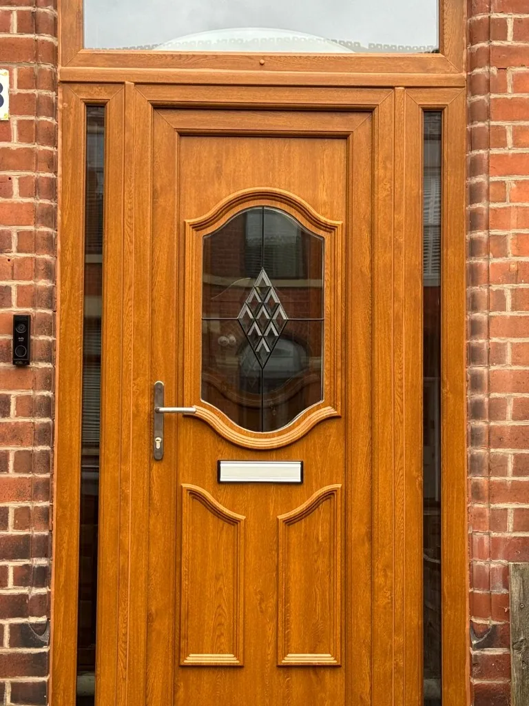 Golden oak front door with sidelights and decorative glass