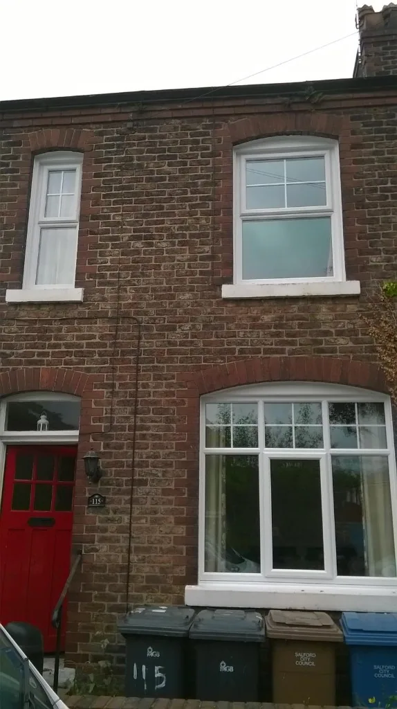 White uPVC windows with Georgian bars and red front door
