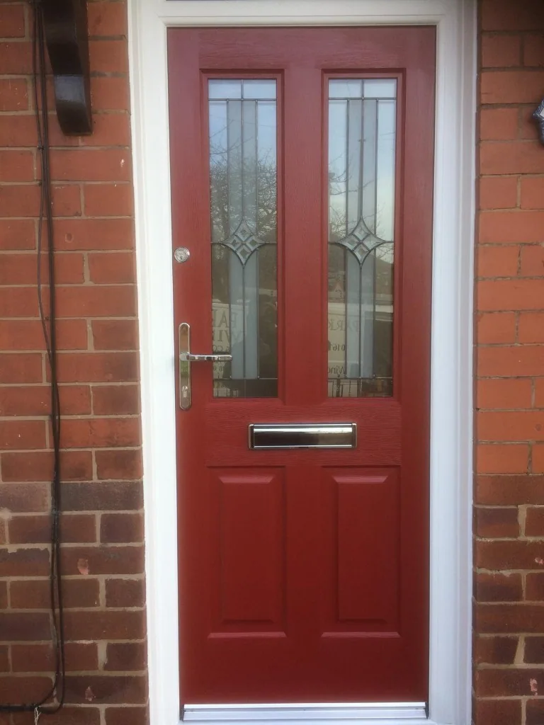 Red composite front door with decorative glazing