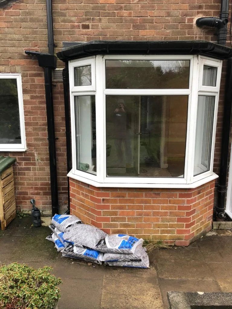 White uPVC bay window on brick dwarf wall