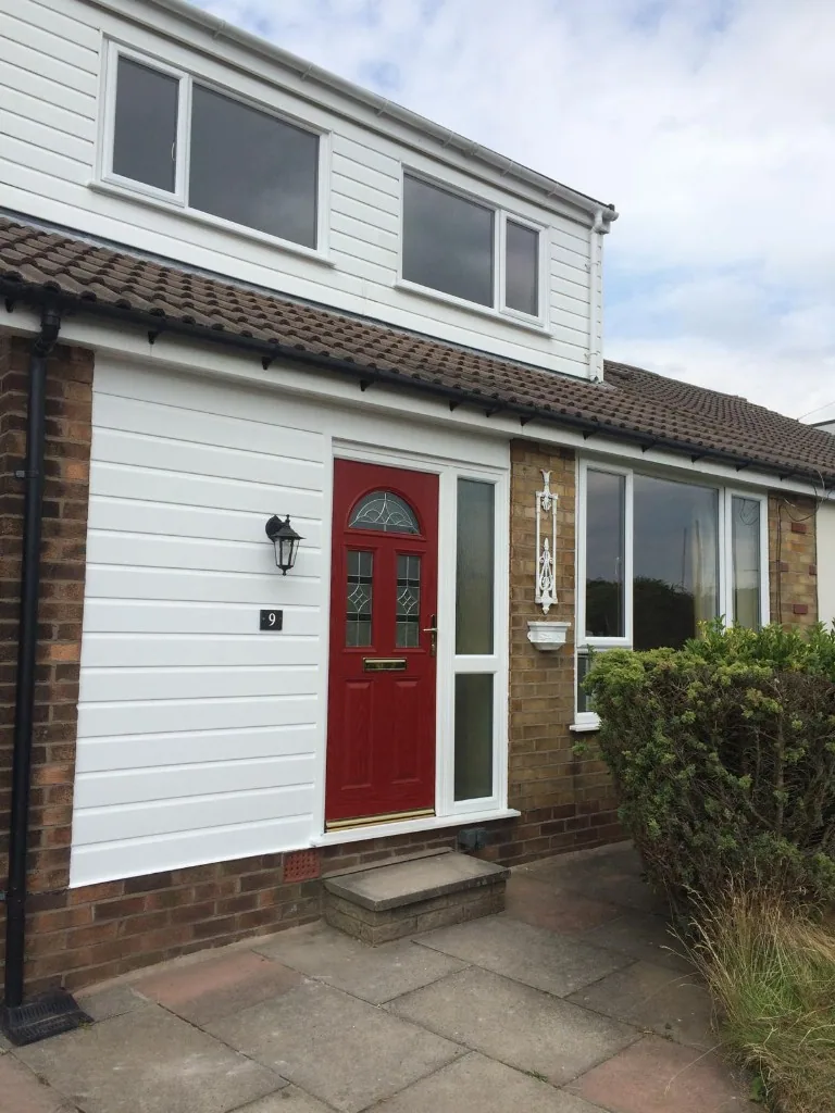 Red composite front door with sidelight and uPVC windows